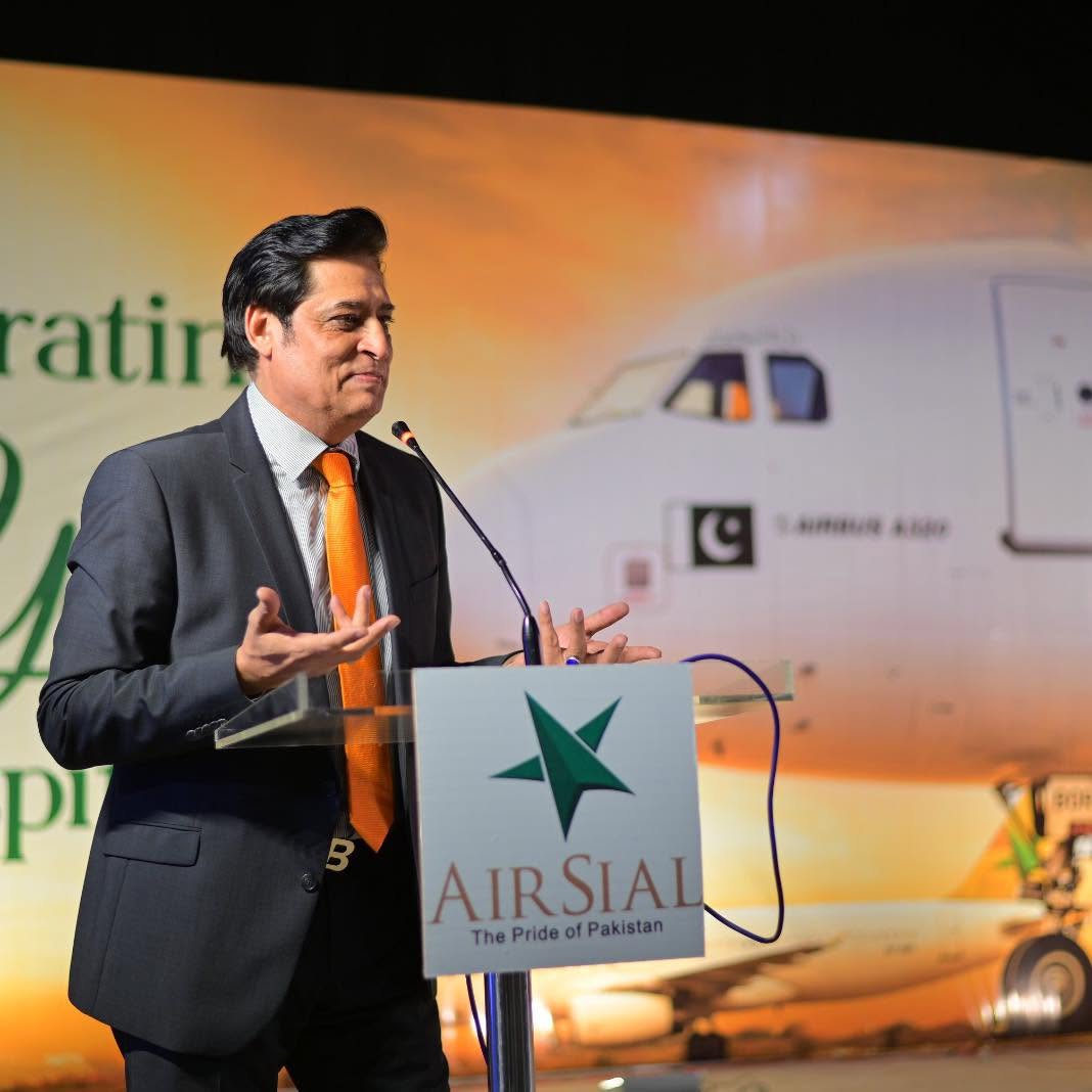 Fazal Jilani at an AirSial ceremony, speaking at a podium bearing the AirSial star logo, with an Airbus A320 behind him